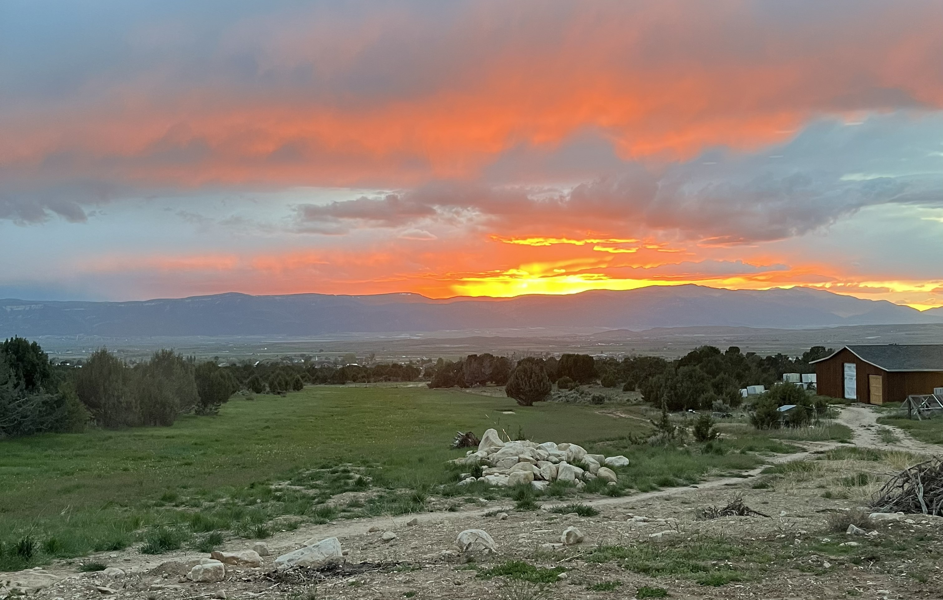 The Rencher Residence — a custom-designed home on 40 acres outside Spring City, Utah, surrounded by sagebrush and junipers with the Sanpete Valley mountains in the background