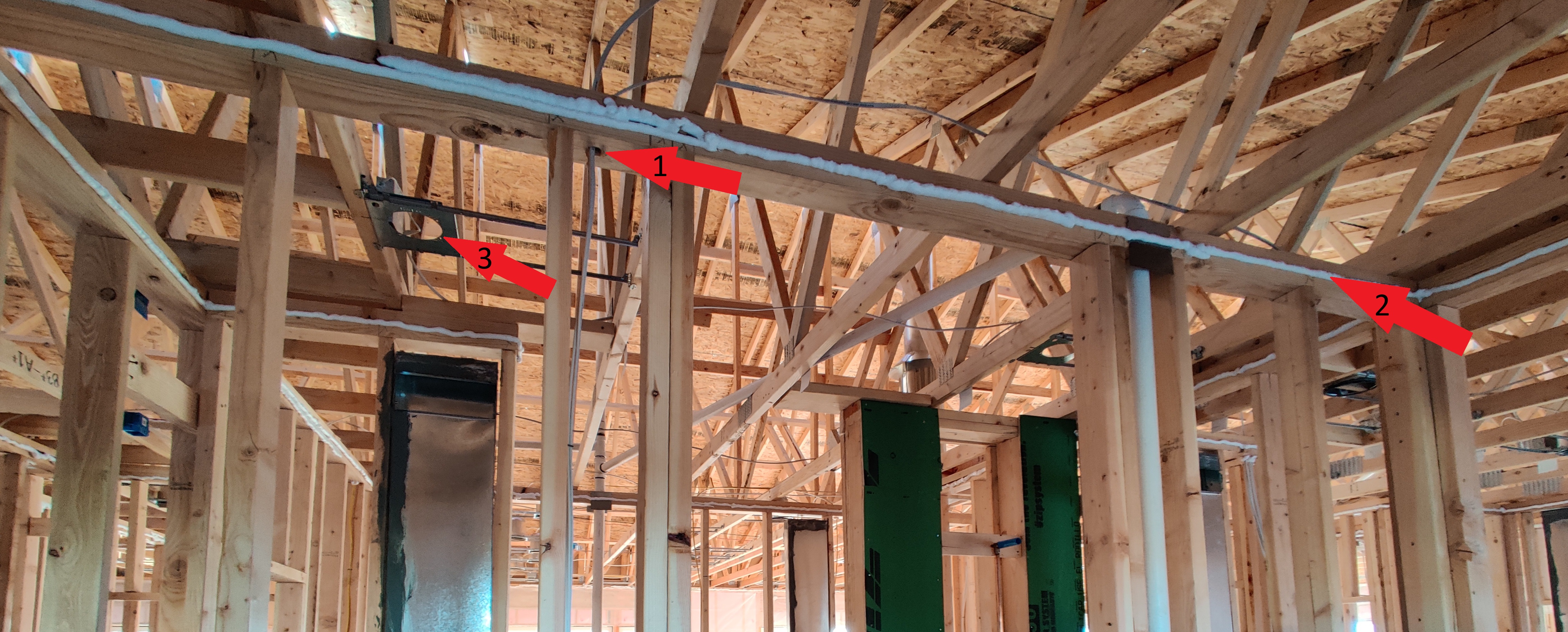 Framing stage of a home under construction — top plates and rim joist visible before insulation, showing the locations where air sealing work happens