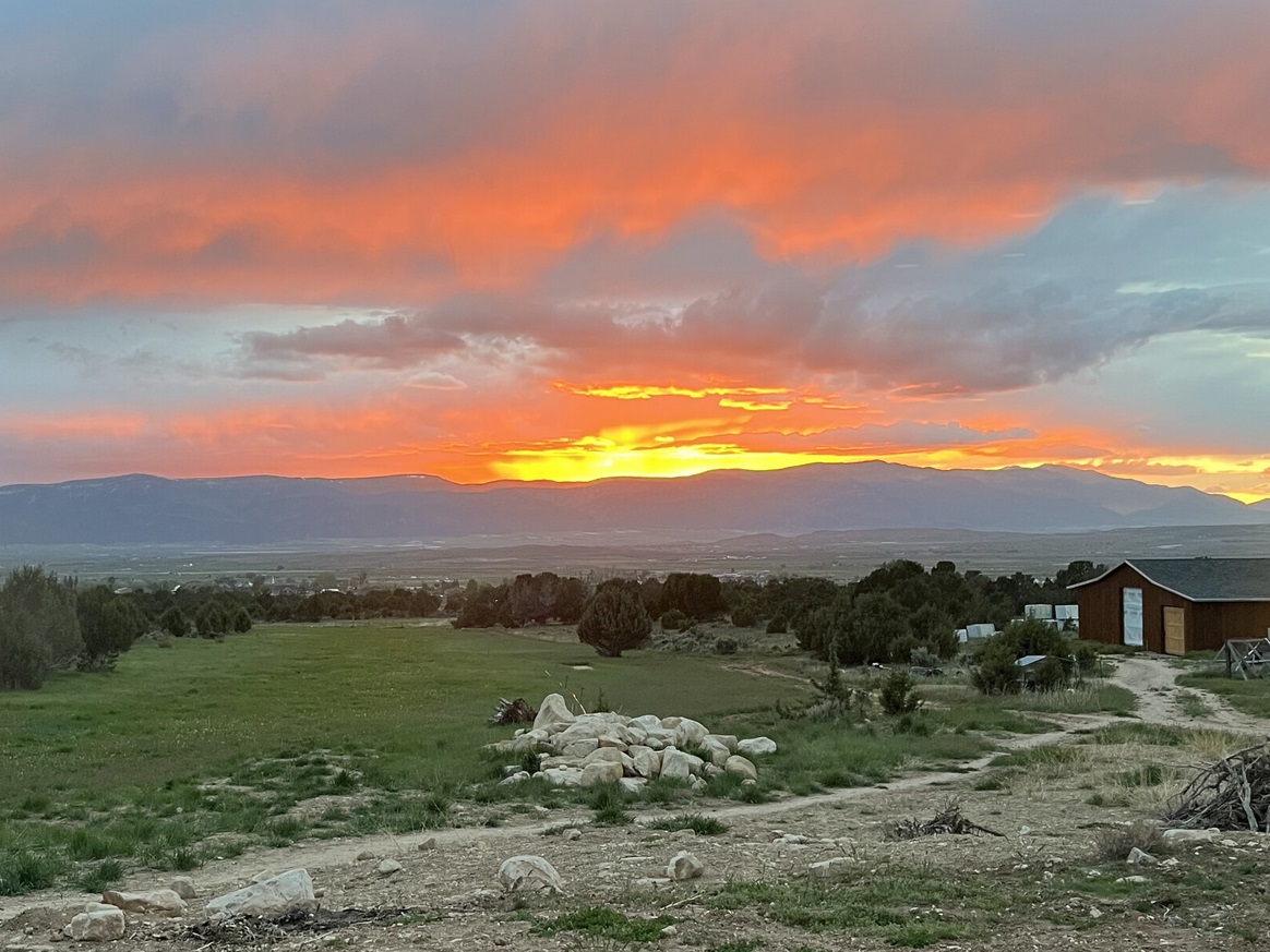 Valley view at sunset showing the Rencher's barn and chicken coop experiments